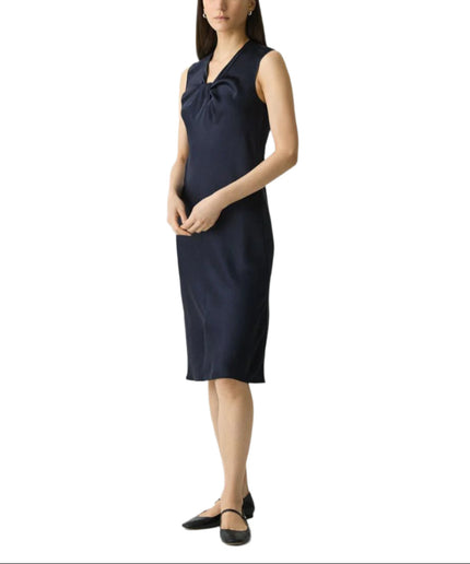 Woman wearing a navy blue dress on a white background