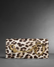 TWISTED GOLD SIDE HANDLE CLUTCH PURSE IN METALLIC LEOPARD