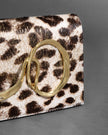 TWISTED GOLD SIDE HANDLE CLUTCH PURSE IN METALLIC LEOPARD