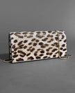 TWISTED GOLD SIDE HANDLE CLUTCH PURSE IN METALLIC LEOPARD