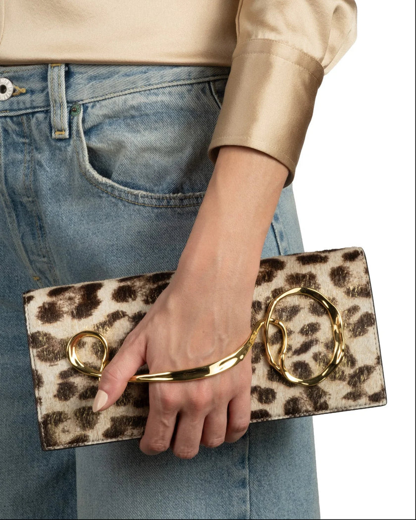 TWISTED GOLD SIDE HANDLE CLUTCH PURSE IN METALLIC LEOPARD